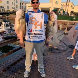 Lake Conroe Fishing Adventures Customer Holds Hybrid Striped Bass on Lake Conroe