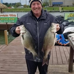 Lake Conroe Fishing Adventures Customer Holds Hybrid Striped Bass on Lake Conroe