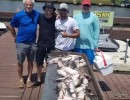Lake Conroe Fishing Adventures Customers Stand Next to Fillet Table Full of Catfish on Lake Conroe