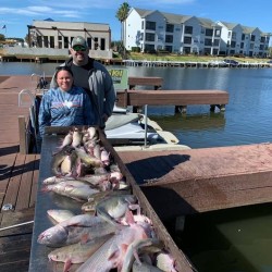 Lake Conroe Fishing Adventures Customers Stand Next to Fillet Table Full of Catfish on Lake Conroe