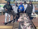 Lake Conroe Fishing Adventures Customers Stand Next to Fillet Table Full of Catfish on Lake Conroe