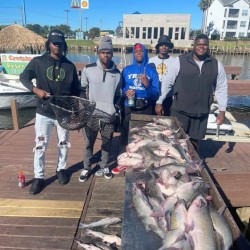 Lake Conroe Fishing Adventures Customers Stand Next to Fillet Table Full of Catfish on Lake Conroe