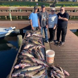 Lake Conroe Fishing Adventures Customers Stand Next to Fillet Table Full of Catfish on Lake Conroe