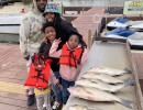 Lake Conroe Fishing Adventures Customers Stand Next to Fillet Table Full of Hybrid Striped Bass on Lake Conroe