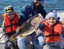 Collin Edwards Licensed Professional Fishing Guide on Lake Conroe Holds Trophy Large Mouth Bass with Young Customers
