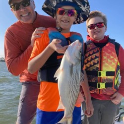 Lake Conroe Fishing Adventures Customers Hold Hybrid Striped Bass on Lake Conroe