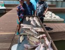 Lake Conroe Fishing Adventures Customers Stand Next to Fillet Table Full of Catfish on Lake Conroe