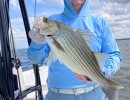 Lake Conroe Fishing Adventures Customer Holds Hybrid Striped Bass on Lake Conroe