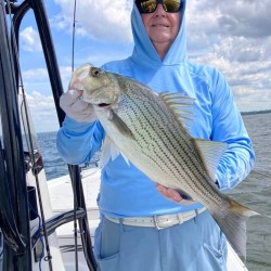 Lake Conroe Fishing Adventures Customer Holds Hybrid Striped Bass on Lake Conroe