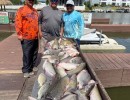 Lake Conroe Fishing Adventures Customers Stand Next to Fillet Table Full of Catfish on Lake Conroe