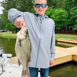 Lake Conroe Fishing Adventures Customer Holds Hybrid Striped Bass