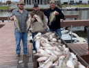 Lake Conroe Fishing Adventures Customers Stand Next to Fillet Table Full of Catfish on Lake Conroe