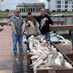 Lake Conroe Fishing Adventures Customers Stand Next to Fillet Table Full of Catfish on Lake Conroe