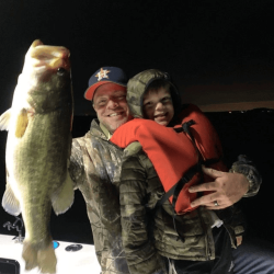 Lake Conroe Fishing Adventures Customers Hold Trophy Large Mouth Bass on Lake Conroe